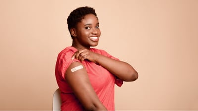 Photo of a person with a bandaid covering a vaccine injection site